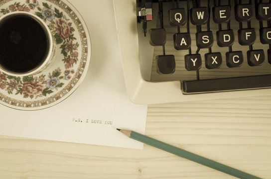Coffee cup, typewriter and I love you message. Old photo style