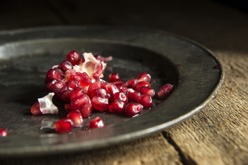 Moody natrual lighting images of fresh juicy pomegranate with vi