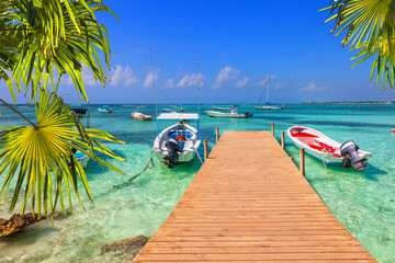 wooden pier and fishing boats on a Caribbean beach