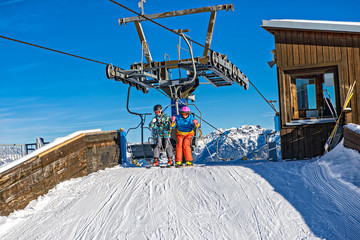Fototapeta na wymiar Skiing, ski lift - skiers on ski vacation