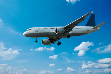 Fototapeta premium Passenger Airliner flying in the clouds