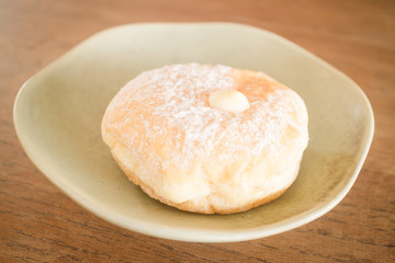 Cream donut on vintage background