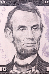 Portrait of Abraham Lincoln on five U.S. dollar bill.