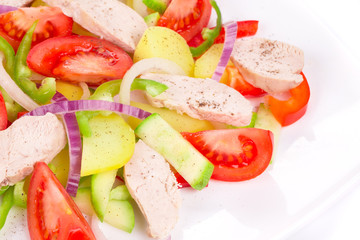 Warm meat salad with vegetables