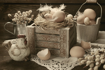 old rustic still life with eggs in nest on wooden box for easter