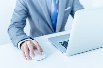 Closeup of businessman hands typing on laptop computer