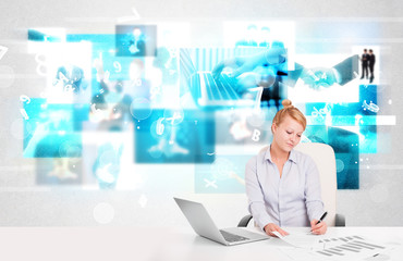 Business person at desk with modern tech images at background