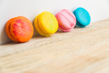Colorful macaron with white background on wooden floor
