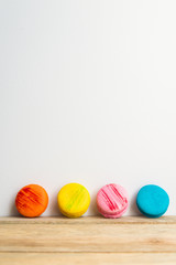 Colorful macaron with white background on wooden floor