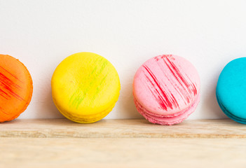 Colorful macaron with white background on wooden floor