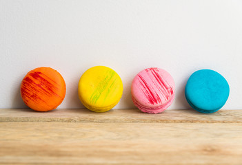 Colorful macaron with white background on wooden floor