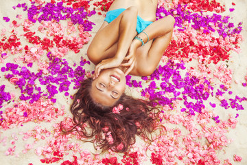 Plakat woman relaxing on a flower petals