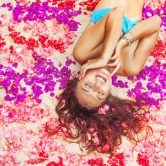 Obraz na płótnie Canvas woman relaxing on a flower petals