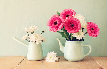 summer bouquet of flowers on the wooden table with mint backgrou