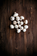 Obraz na płótnie Canvas White mushrooms on wood table