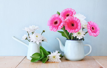 summer bouquet of flowers on the wooden table with mint backgrou