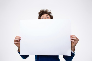 Man holding blank paper and looking at camera