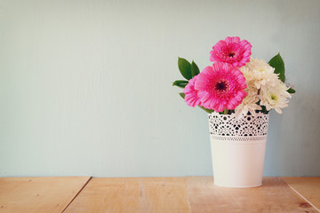 summer bouquet of flowers on the wooden table with mint backgrou