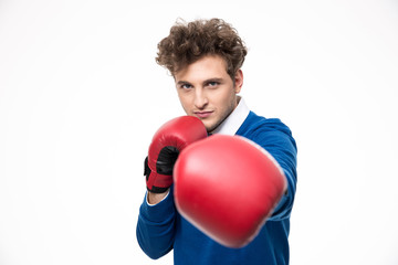 Business man in boxing gloves punching at the camera