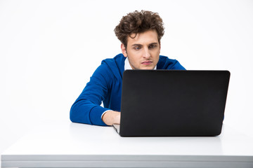 Serious man working on the laptop over white background