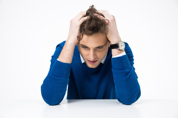 Pensive businessman sitting at the table