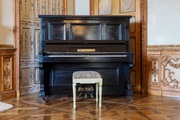 Fototapeta na wymiar Vintage black piano instrument in stylish elegant room