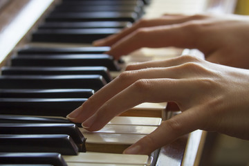 Girl's hands on piano