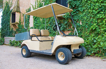 Parked golf cart near the house.