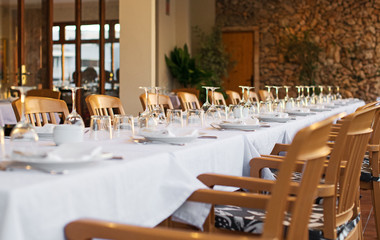Setout table with tableware in modern restaurant.
