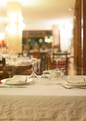 Setout table with tableware in modern restaurant.