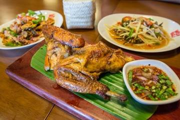 Grilled chicken served with papaya salad.