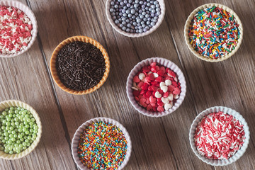 Colorful cupcake wrappers over a wooden table