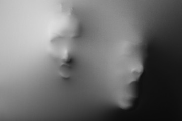 Screaming human faces pressing through fabric as horror
