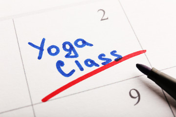 Written plan Yoga Class on calendar page background