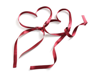 Brown ribbon in shape of hearts isolated on white