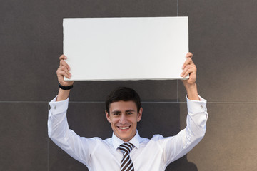 Businessman showing blank signboard