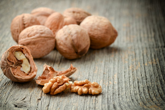 A lot of nuts on wooden background