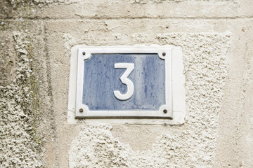 Number three on the wall of a house