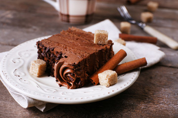 Tasty piece of chocolate with lump sugar and cinnamon sticks