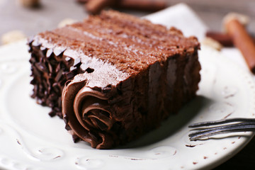 Tasty piece of chocolate with lump sugar and cinnamon sticks