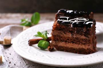 Tasty pieces of chocolate cake with mint and cinnamon