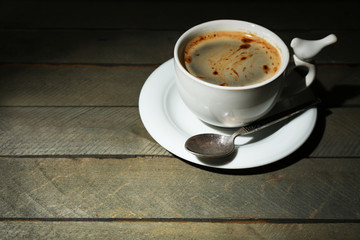 Cup of coffee on rustic wooden planks background