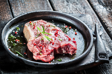 Closeup of beef with rosemary and pepper ready to grill