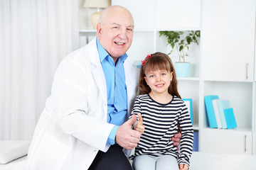 Little girl and old doctor in hospital