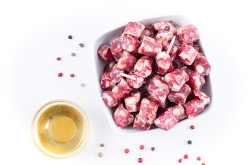 dry sausage cutted in small pieces in a bowl and honey
