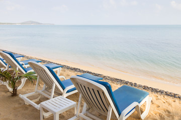 Fototapeta na wymiar Beach chairs at the empty Maenam Beach in Koh Samui, Thailand