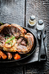 Grilled vegetables and steak with fresh herbs on barbecue dish