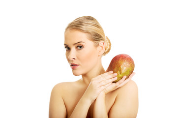 Nude woman holding a mango