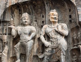Fototapeta na wymiar Two stone buddhist statues in Longmen Grottoes