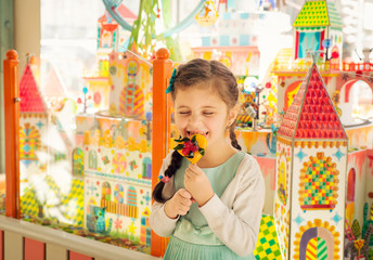 Happy girl licking candy